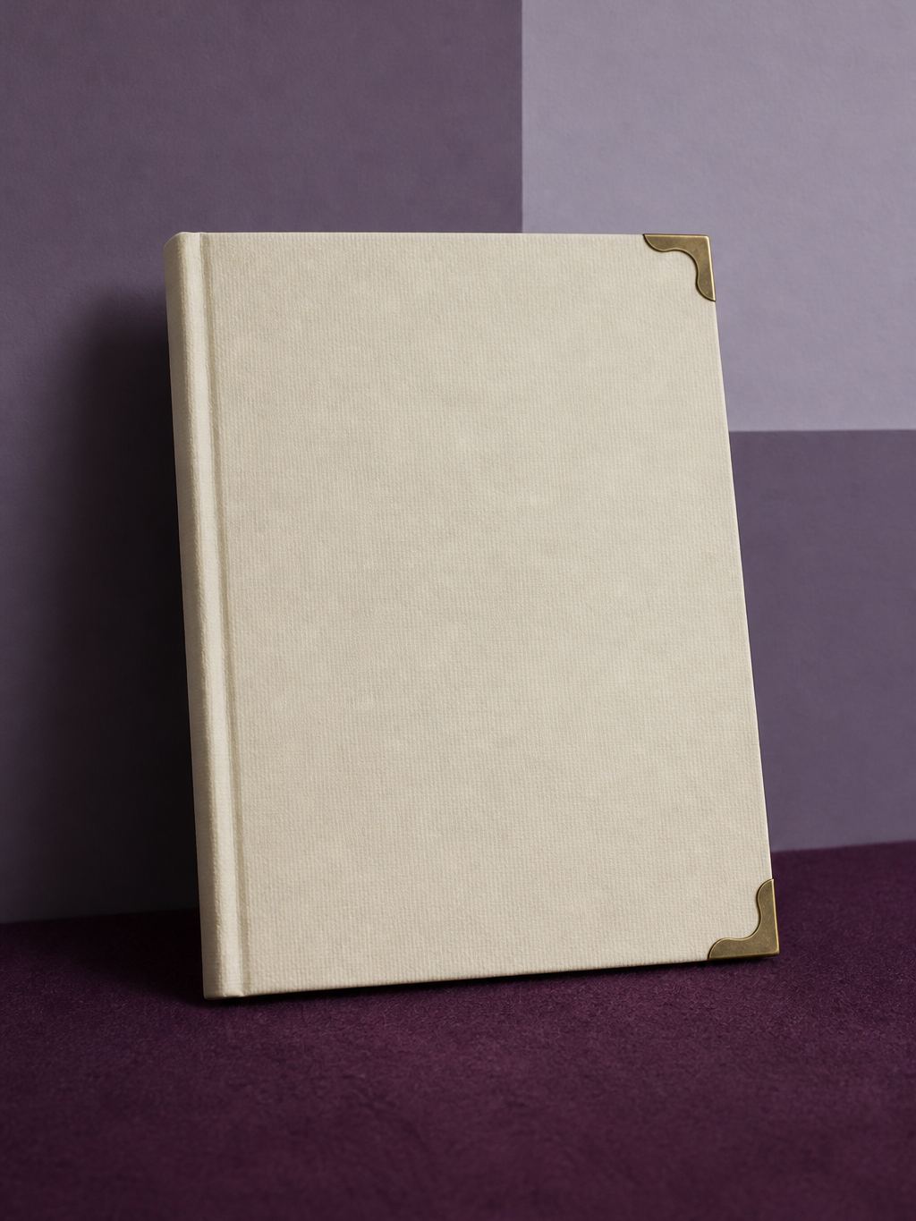 Cream booklet with brass corner protectors on plum felt