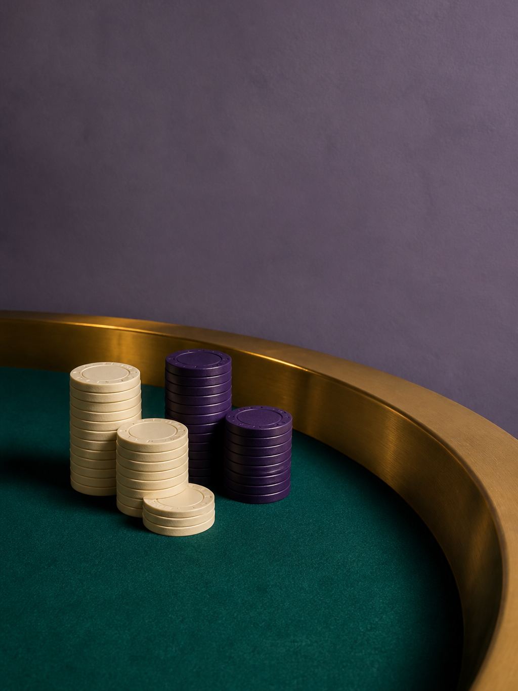 Casino table rail in brass against plum felt