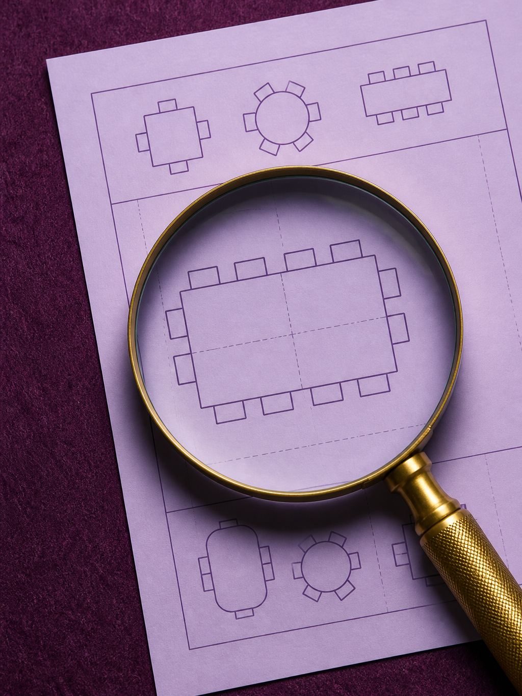 Magnifying glass over a table plan